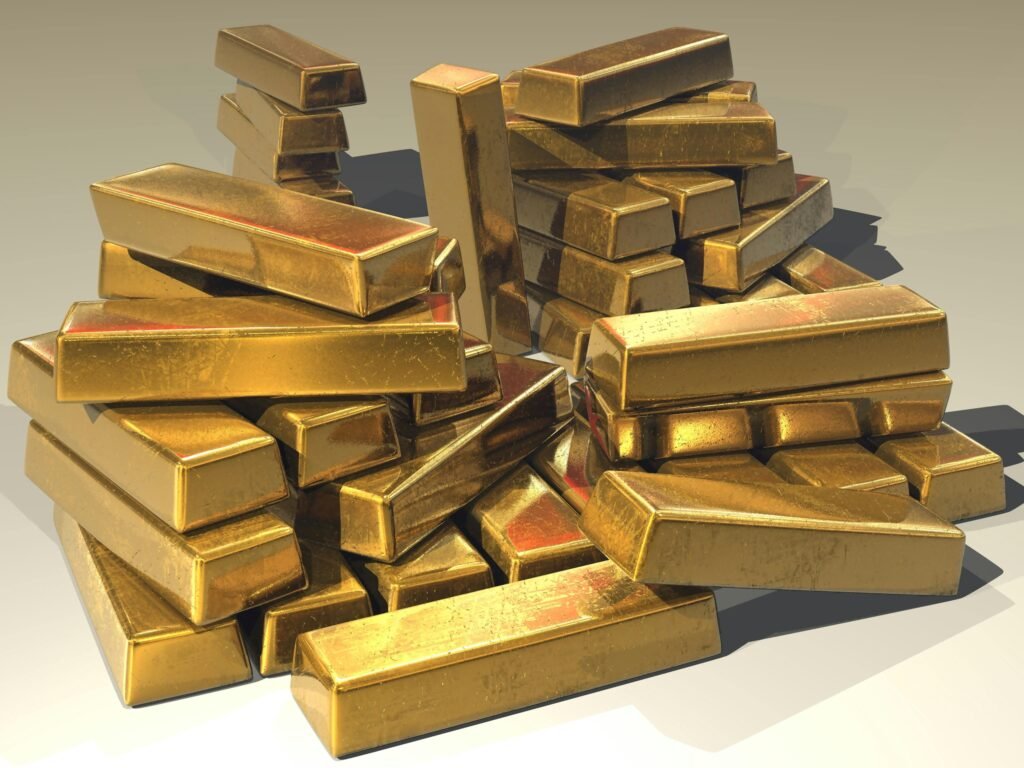 gold-ingots-golden-treasure-47047-47047 A pile of lustrous gold bars symbolizing wealth and prosperity.