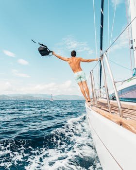 pexels-photo-1223649-1223649 Man enjoying freedom by jumping into the ocean from a sailboat in Greece.