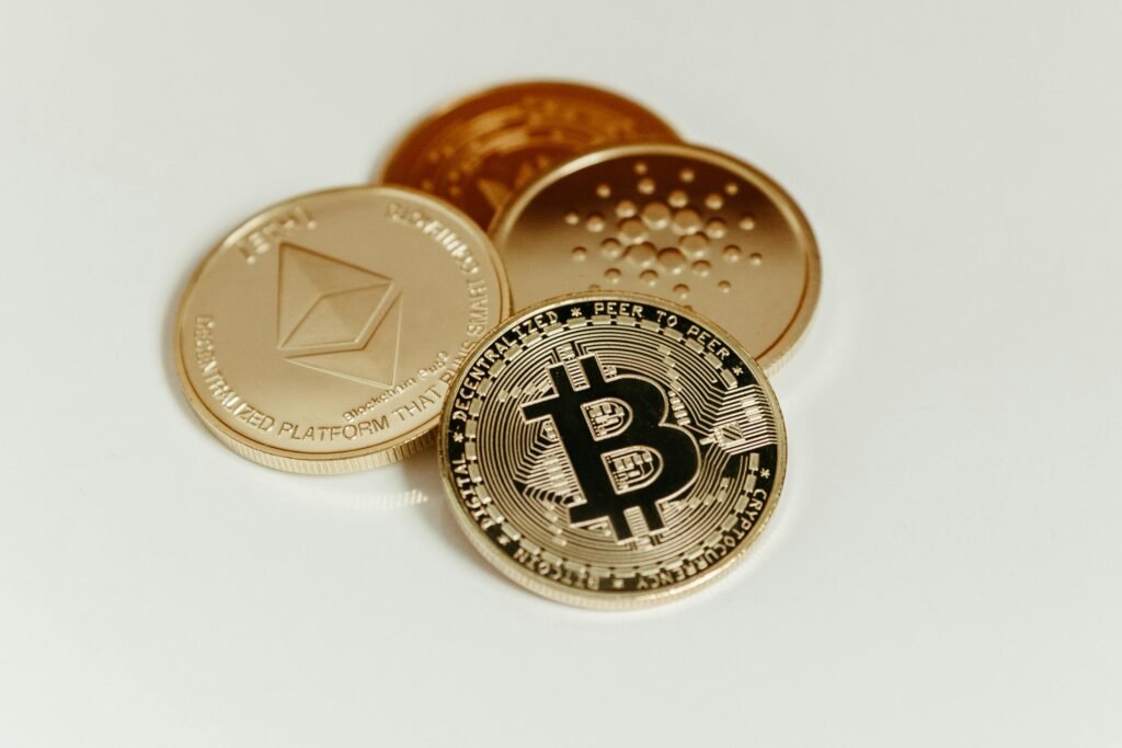 pexels-photo-14832156-14832156 Close-up of Bitcoin, Ethereum, and Cardano coins on a plain background, showcasing digital currency.