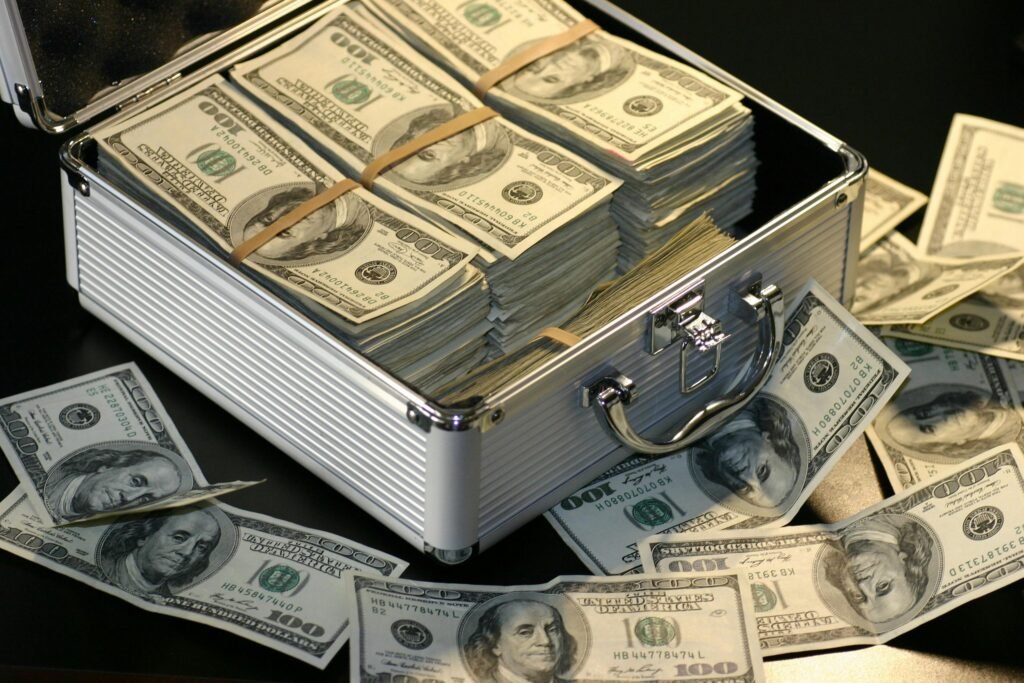 pexels-photo-164652-164652 A metallic briefcase full of US dollar bills, symbolizing wealth and investment.