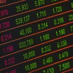 Close-up of a digital stock market data display showing colorful financial numbers and trends.