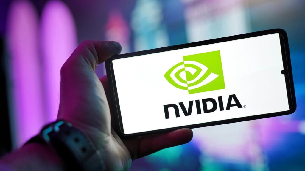 pexels-photo-30608594-30608594 Close-up of a hand holding a smartphone showing the NVIDIA logo on screen with a blurred background.