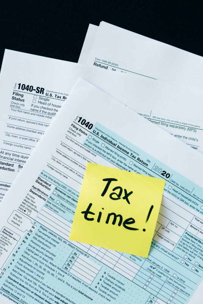 pexels-photo-6863245-6863245 IRS 1040 tax forms with handwritten 'Tax Time!' note for filing reminder.