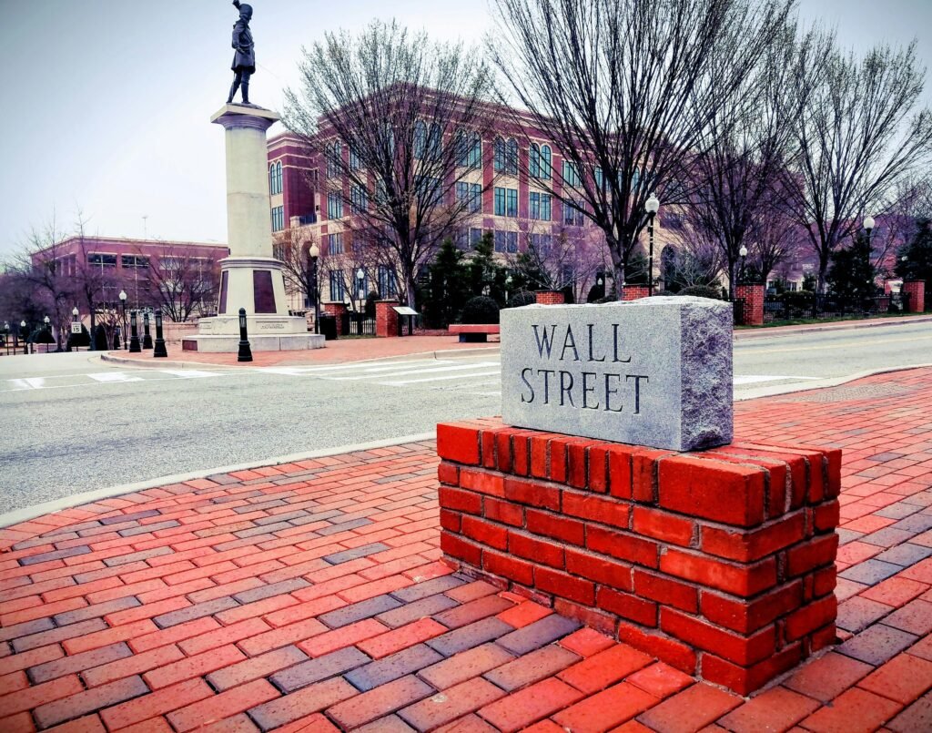 pexels-photo-913200-913200 Brick sculpture of Wall Street in Spartanburg's historic area shows red bricks and iconic statue.