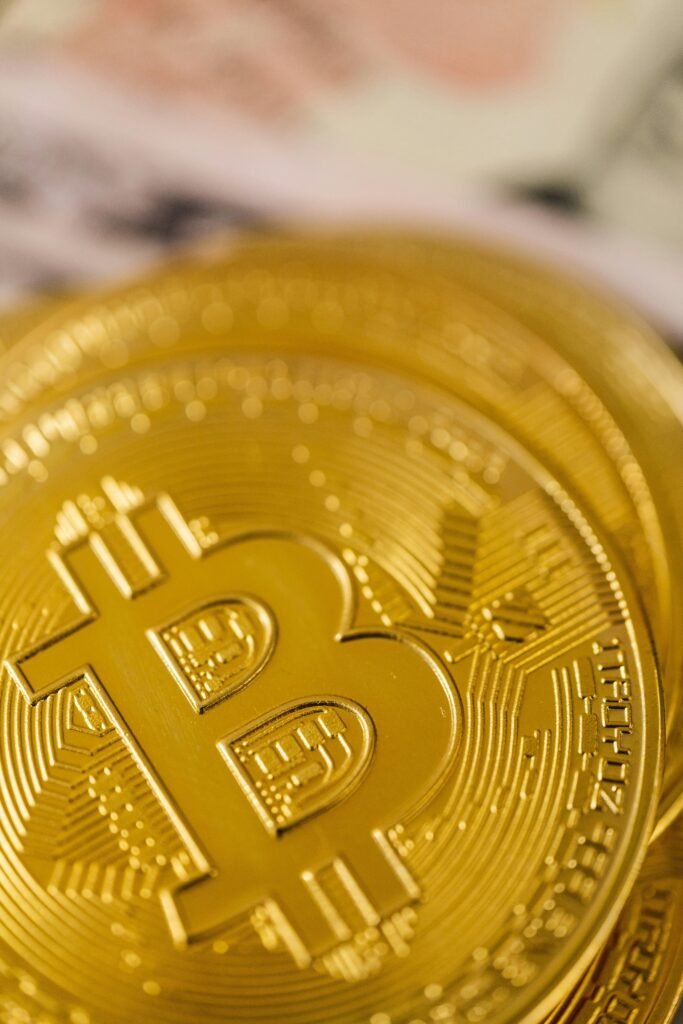 Close-up shot of a gleaming gold Bitcoin, symbolizing cryptocurrency and digital wealth.